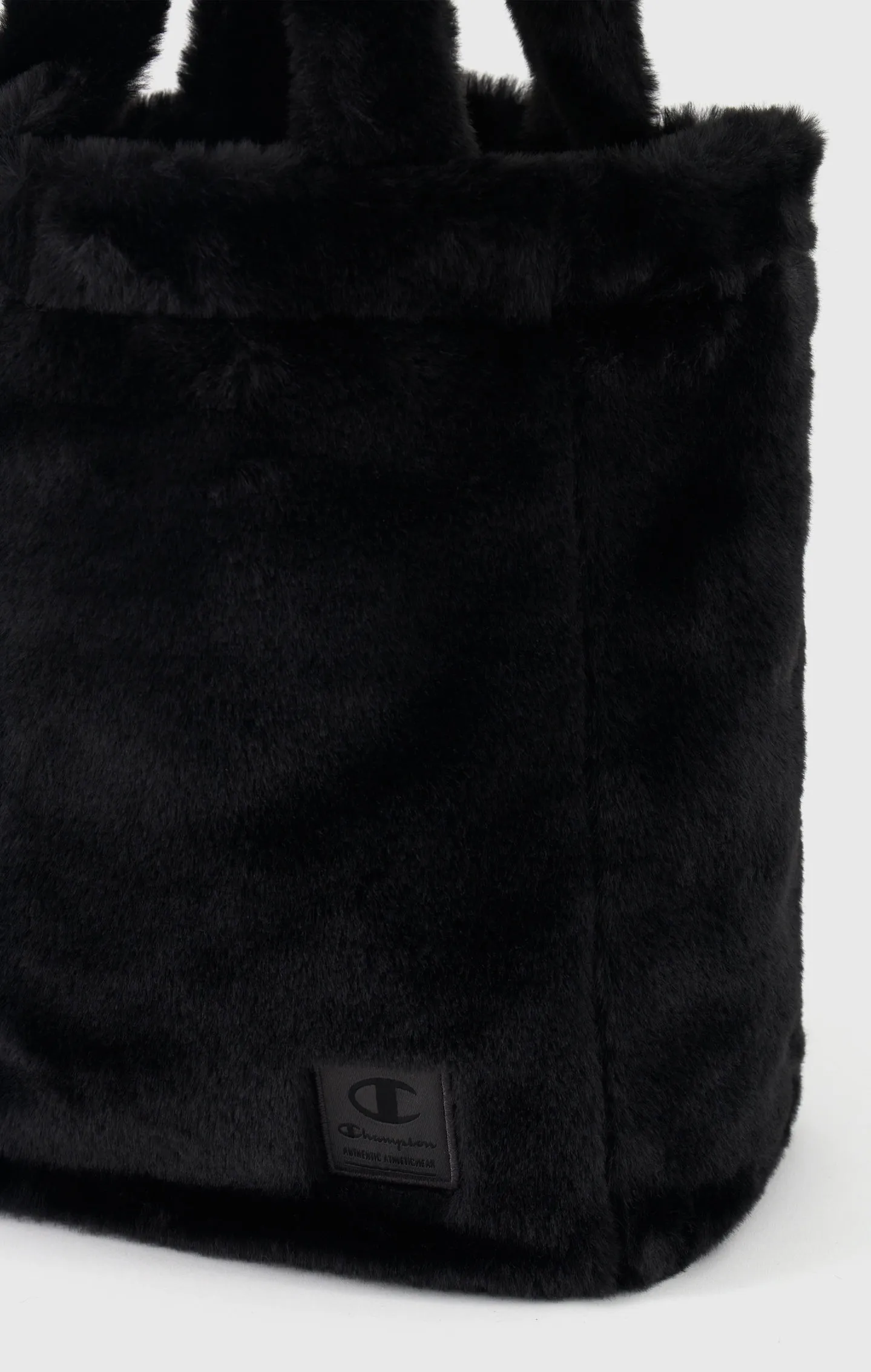 Bolso de pelo falso con etiqueta de jacquard