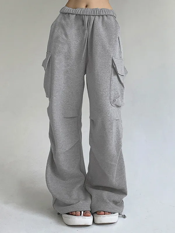 Pantalones deportivos plisados con bolsillo de color liso