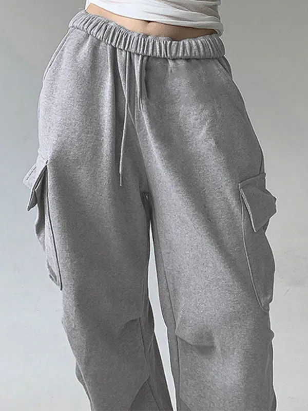 Pantalones deportivos plisados con bolsillo de color liso