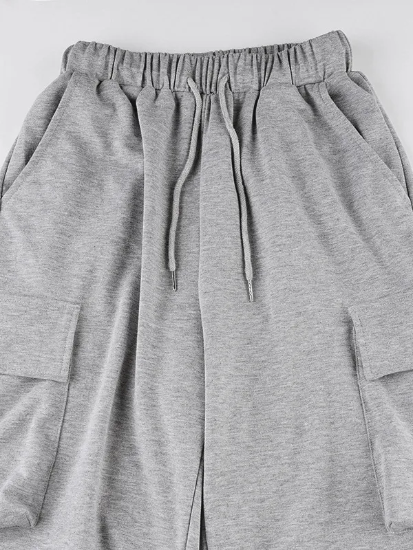 Pantalones deportivos plisados con bolsillo de color liso