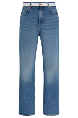 Vaqueros en denim azul medio con cinta de logos en la cintura