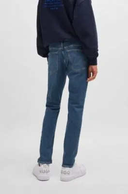 Vaqueros extra slim fit de denim elástico azul marino con lavado a la piedra
